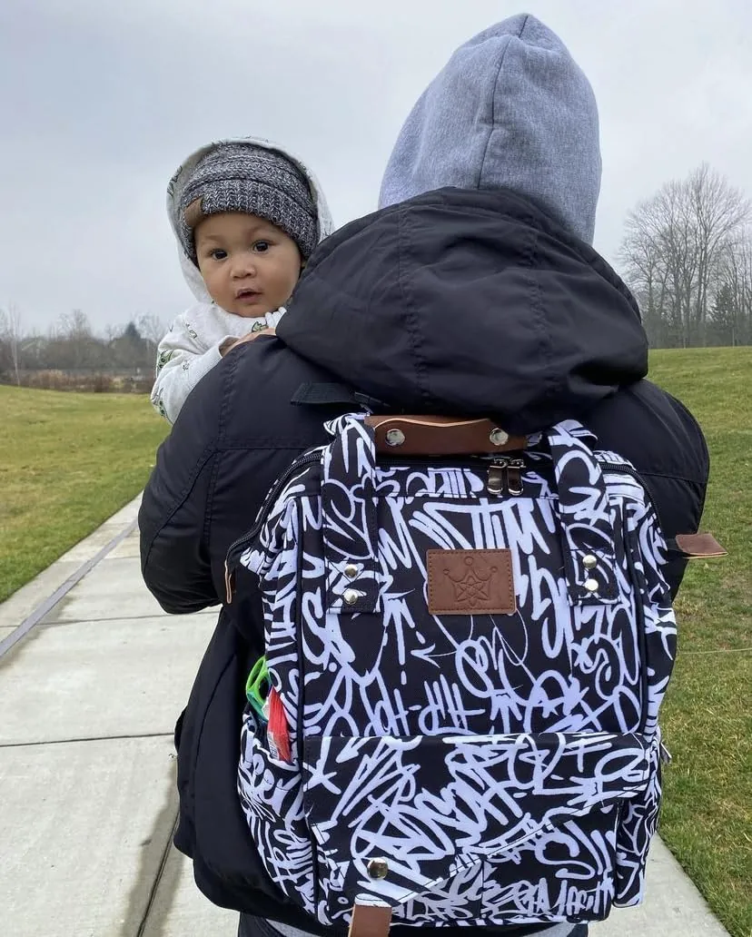 A parent carrying a baby on one shoulder while wearing the bag.