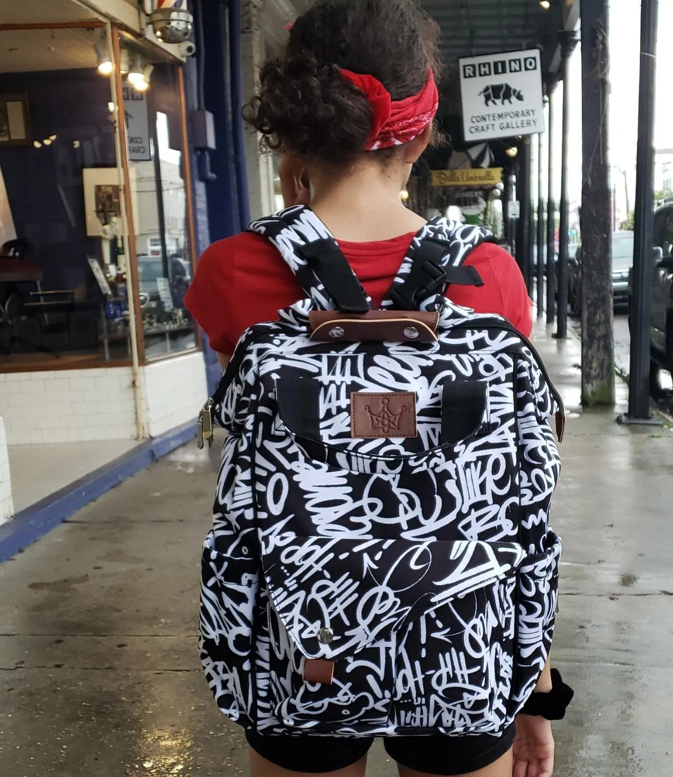 Someone wearing the bag on a rain-wet New Orleans street.